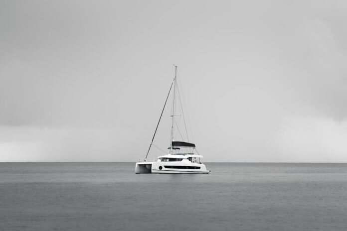 catamaran-sailing-across-clear-tropical-water Catamaran sailing across clear tropical water