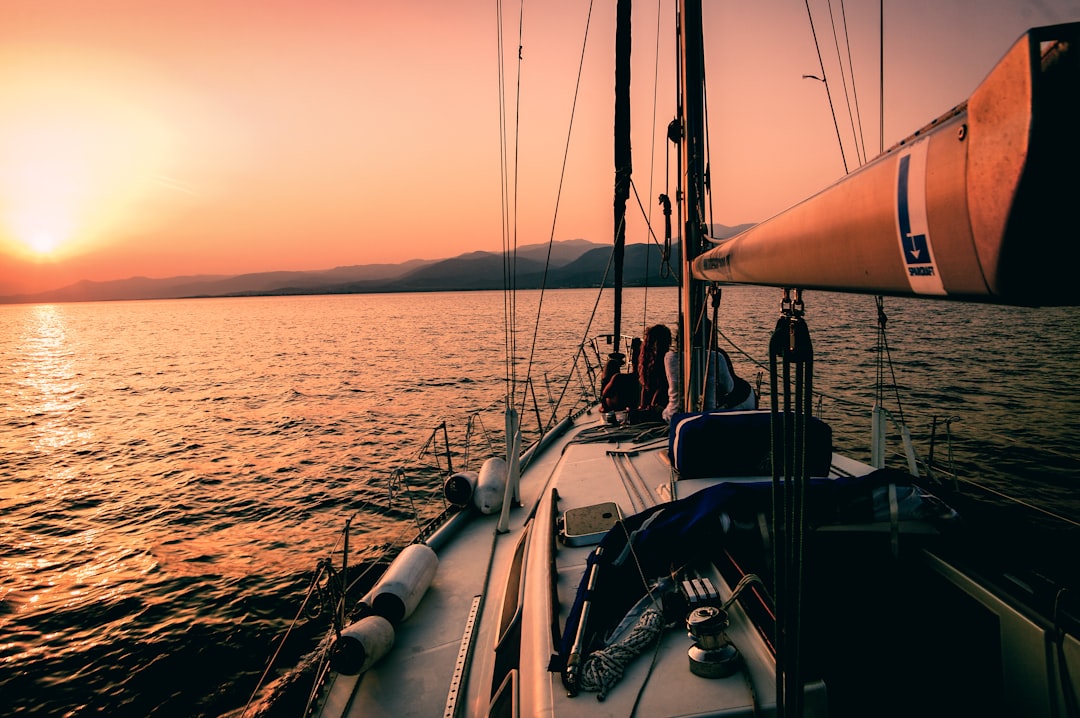 Why We’re Trading the Traditional Life for a Life on the Water Sailboat at sunset representing Michael and Kristal's dream of living on the water