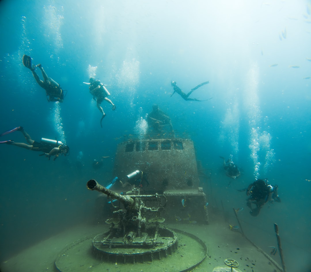 Scuba divers exploring an underwater shipwreck