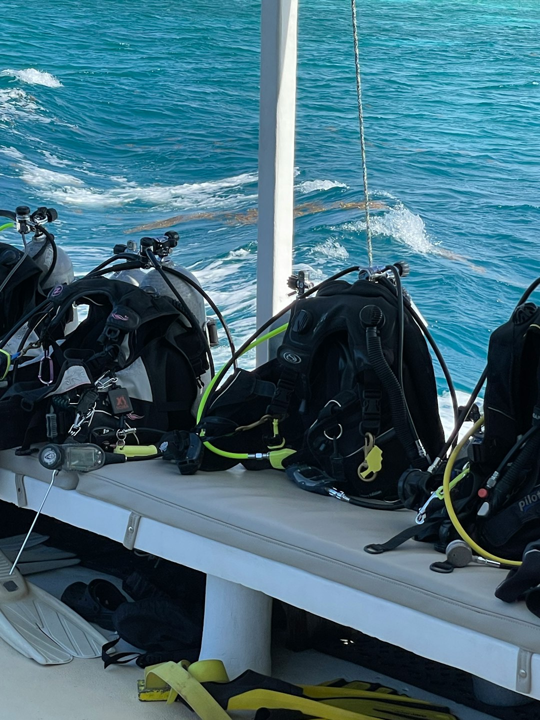 Scuba gear and tanks lined up on a dive boat