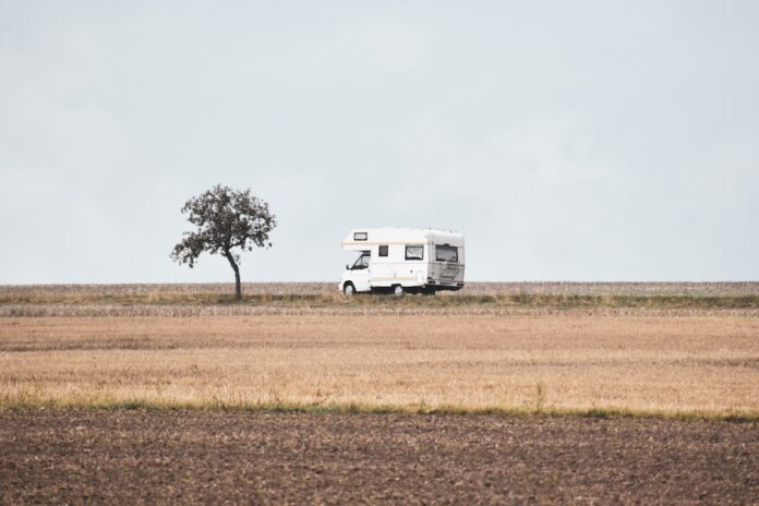 travel-trailer-and-truck-in-the-countryside-during-a-transit Travel trailer and truck in the countryside during a transition to simpler living