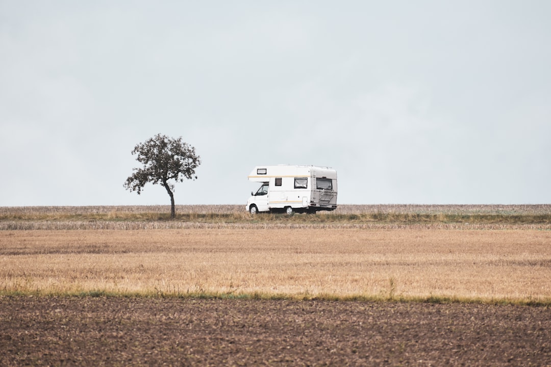 From House to RV to Sailboat: Why We’re Taking the Long Way to the Water Travel trailer and truck in the countryside during a transition to simpler living